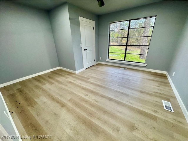 unfurnished room with light hardwood / wood-style flooring