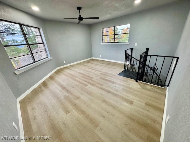 unfurnished living room with light hardwood / wood-style floors and ceiling fan