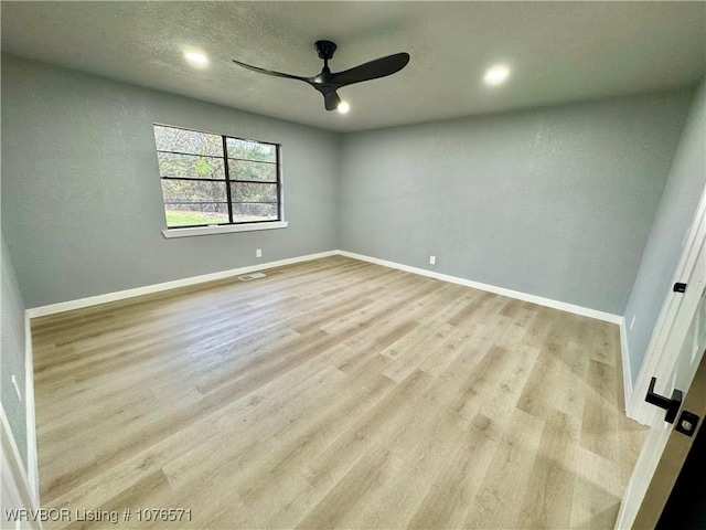 empty room featuring ceiling fan and light hardwood / wood-style floors