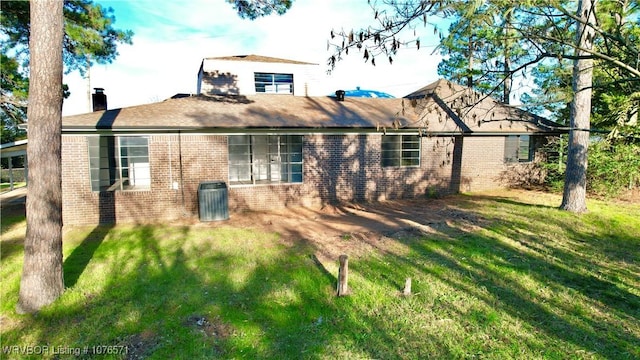 back of property featuring a lawn