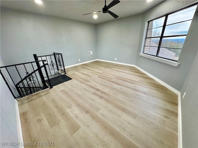 unfurnished room with ceiling fan and light hardwood / wood-style floors