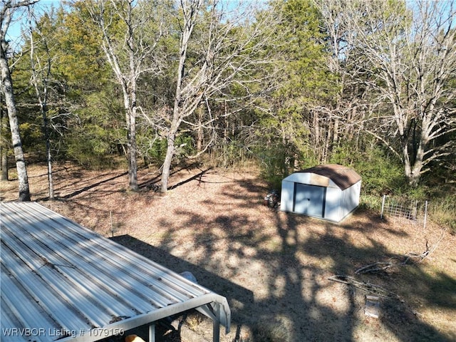 view of yard with an outbuilding and a shed