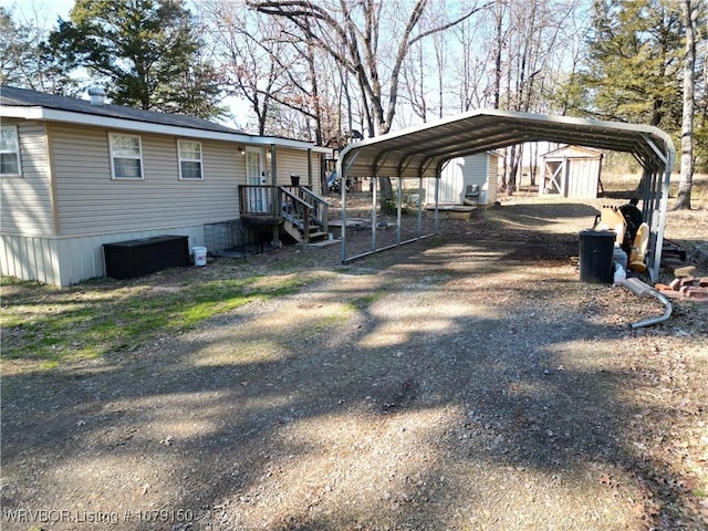 exterior space with a detached carport and dirt driveway