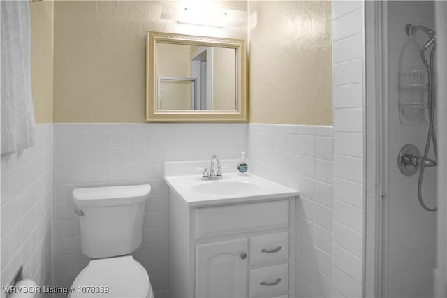 bathroom featuring tile walls, walk in shower, vanity, and toilet