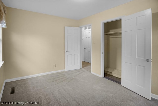 unfurnished bedroom featuring a closet and light carpet