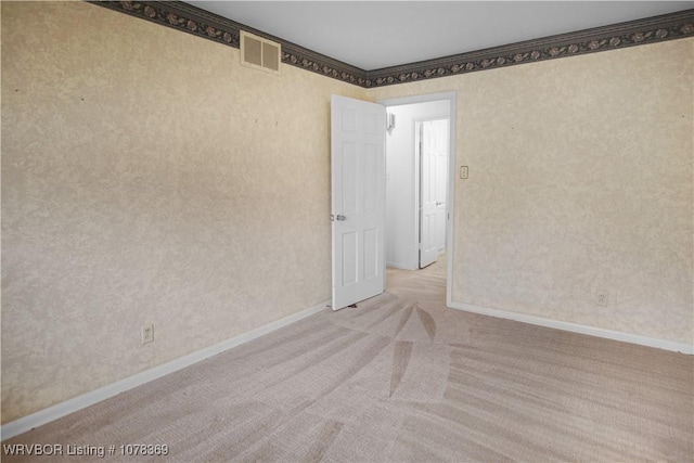 carpeted spare room with crown molding