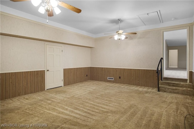 carpeted spare room featuring ceiling fan