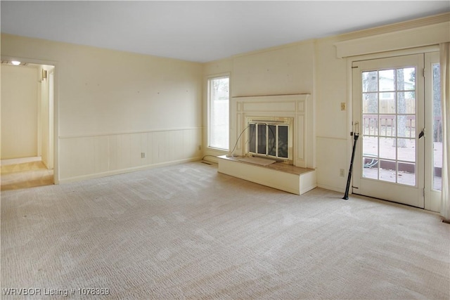 unfurnished living room featuring light carpet