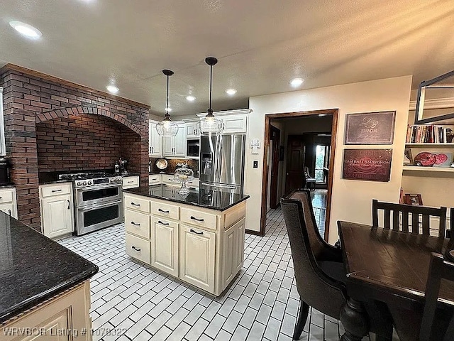 kitchen with pendant lighting, a center island, and appliances with stainless steel finishes