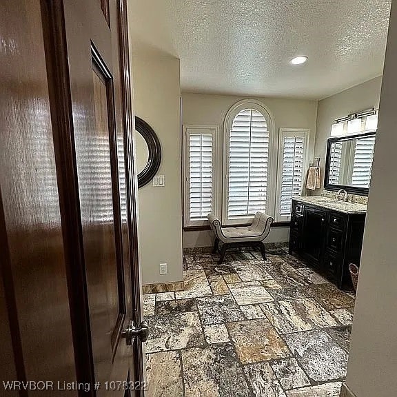 bathroom featuring vanity and a textured ceiling