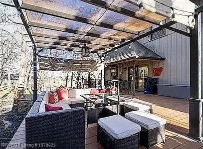 deck featuring a pergola and an outdoor hangout area