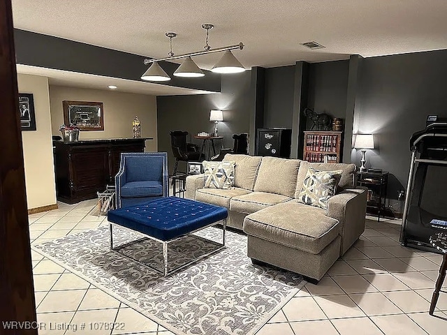 living room featuring light tile patterned floors and a textured ceiling