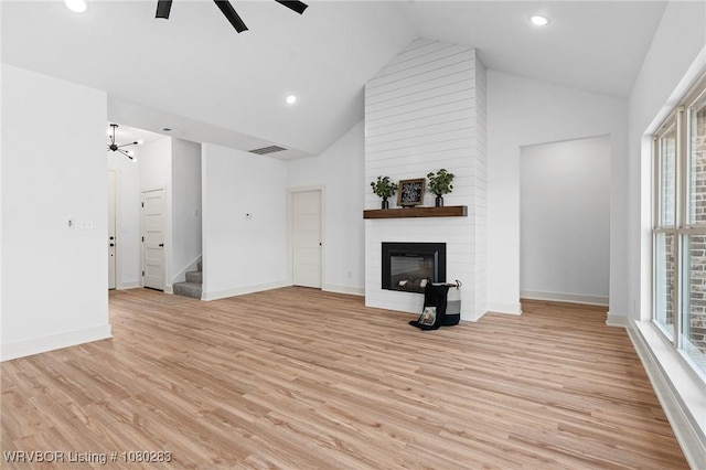 1900 Yellowstone Dr, Barling, AR 72923 - unfurnished living room featuring a large fireplace, ceiling fan, a healthy amount of sunlight, and stairs