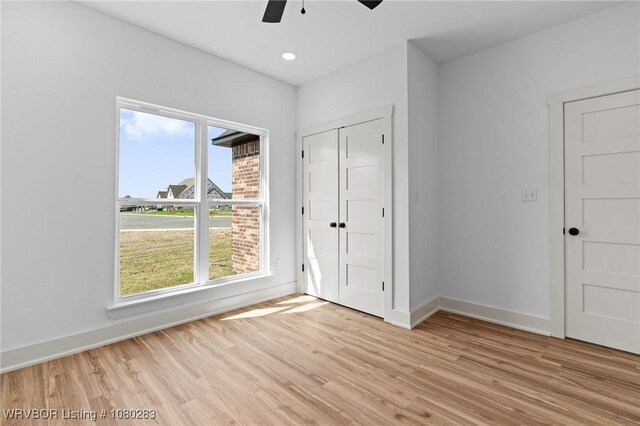 1900 Yellowstone Dr, Barling, AR 72923 - unfurnished bedroom with a closet, light wood finished floors, baseboards, and a ceiling fan