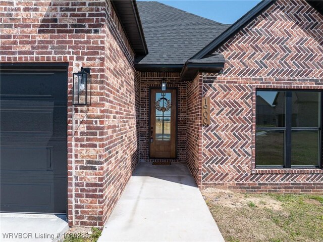 1900 Yellowstone Dr, Barling, AR 72923 - entrance to property featuring brick siding, an attached garage, and a shingled roof