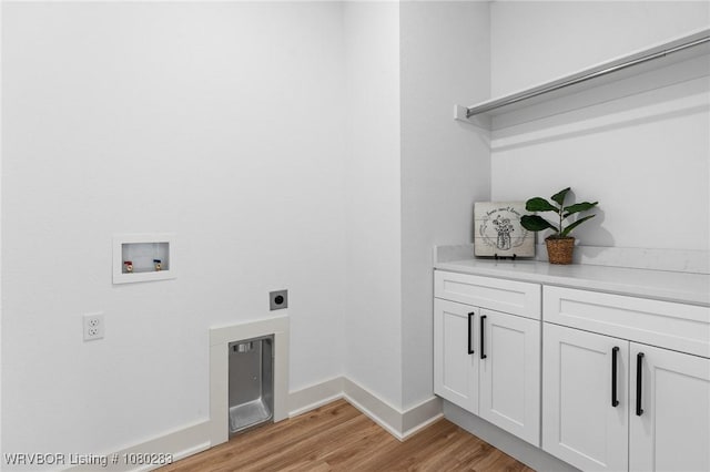 1900 Yellowstone Dr, Barling, AR 72923 - clothes washing area featuring hookup for a washing machine, electric dryer hookup, light wood-type flooring, baseboards, and cabinet space