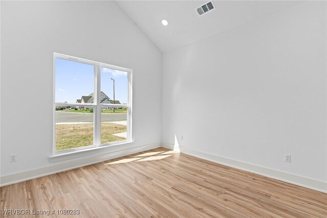 1900 Yellowstone Dr, Barling, AR 72923 - empty room featuring light wood-type flooring, high vaulted ceiling, baseboards, and visible vents