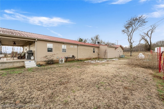 back of house with ceiling fan