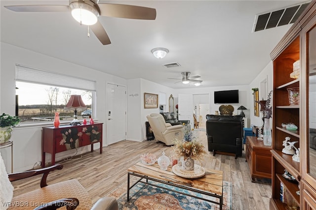 living room featuring ceiling fan and light hardwood / wood-style flooring