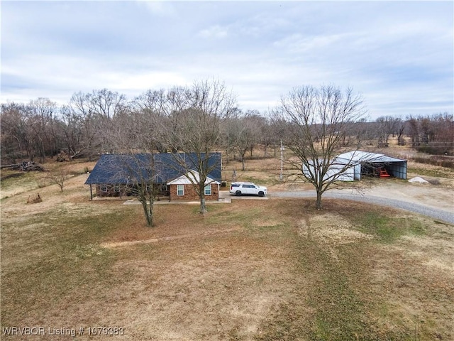 view of yard with dirt driveway