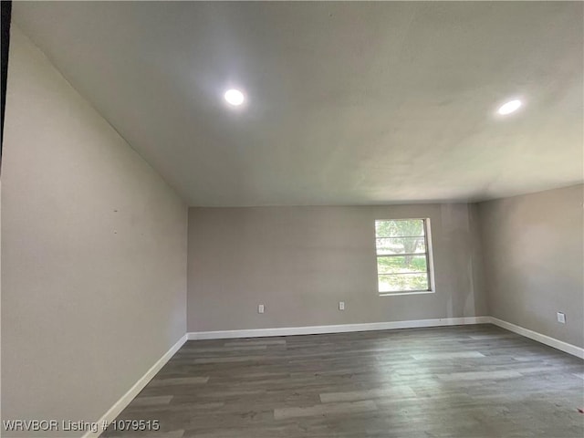 unfurnished room with recessed lighting, baseboards, and dark wood finished floors
