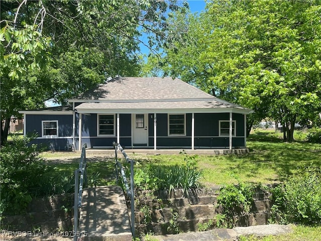 view of front of house with a shingled roof and a porch