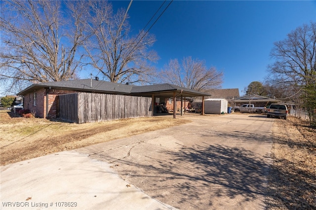 view of front of house with a storage shed and a carport