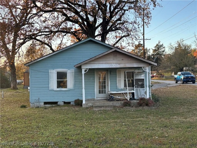 bungalow-style house with a porch and a front yard