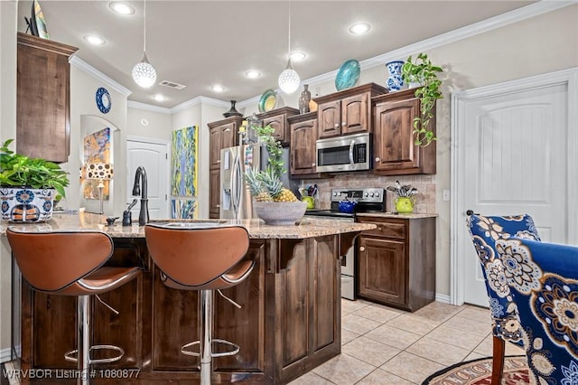 9019 Gracie Ln, Fort Smith, AR 72916 - kitchen with stainless steel appliances, a kitchen breakfast bar, decorative backsplash, recessed lighting, and dark brown cabinets