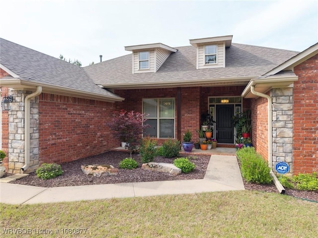 9019 Gracie Ln, Fort Smith, AR 72916 - property entrance with roof with shingles, stone siding, and brick siding