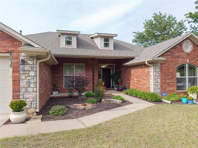 9019 Gracie Ln, Fort Smith, AR 72916 - view of front of house with brick siding, roof with shingles, a front lawn, and stone siding