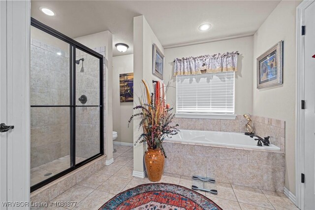 9019 Gracie Ln, Fort Smith, AR 72916 - bathroom with tile patterned flooring, a shower stall, toilet, a garden tub, and baseboards
