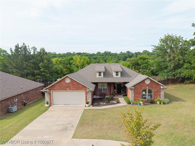 9019 Gracie Ln, Fort Smith, AR 72916 - view of front of home featuring brick siding, a front yard, a garage, and driveway