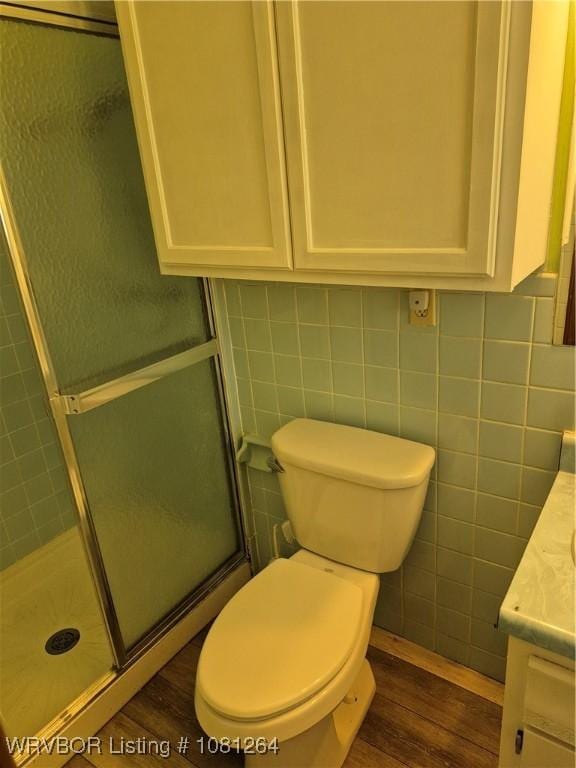 1382 6th St, Waldron, AR 72958 - bathroom featuring vanity, wood finished floors, a shower stall, and toilet