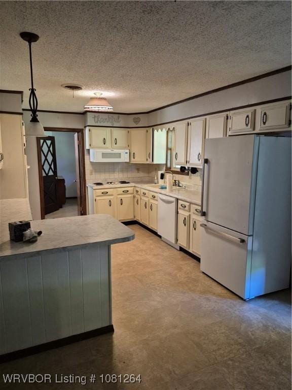 1382 6th St, Waldron, AR 72958 - kitchen featuring white appliances, a textured ceiling, light countertops, hanging light fixtures, and white cabinets