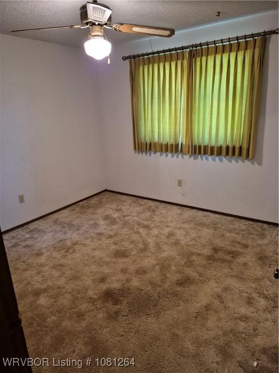 1382 6th St, Waldron, AR 72958 - spare room with carpet flooring, plenty of natural light, ceiling fan, and a textured ceiling