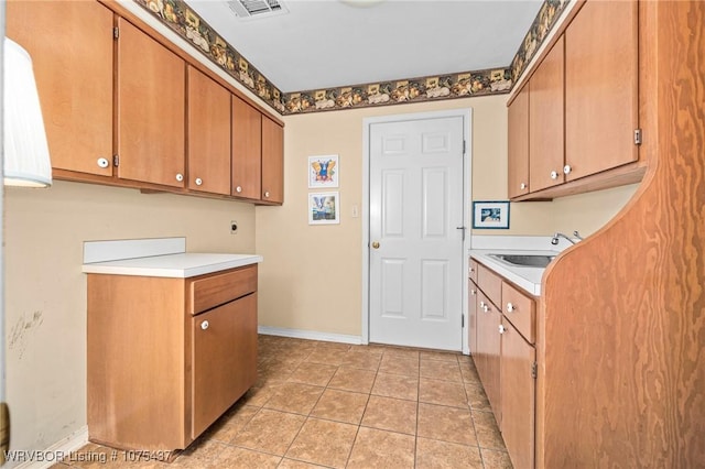 kitchen with sink and light tile patterned floors