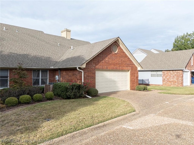 ranch-style home with a garage and a front yard