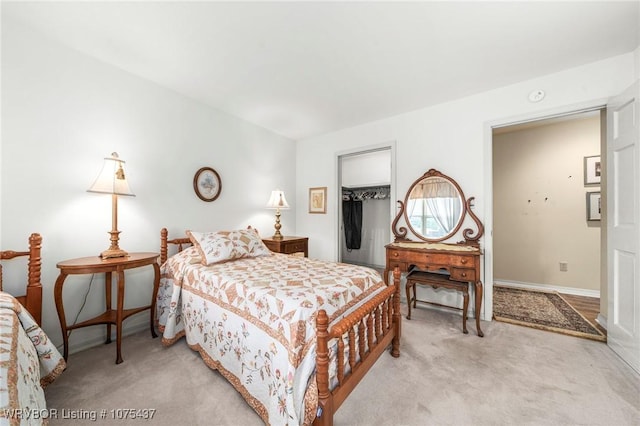 carpeted bedroom with a spacious closet and a closet