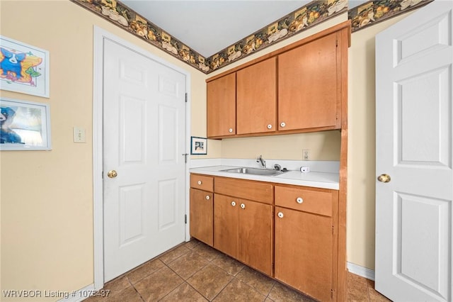 kitchen featuring dark tile patterned floors and sink