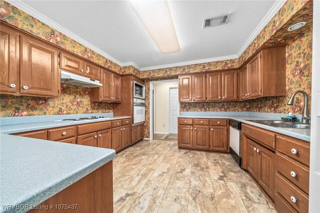 kitchen featuring white appliances, crown molding, and sink