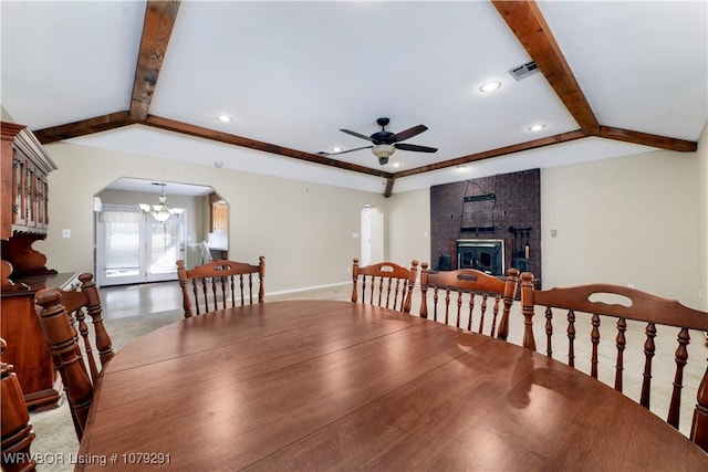 dining space featuring arched walkways, vaulted ceiling with beams, recessed lighting, visible vents, and ceiling fan with notable chandelier