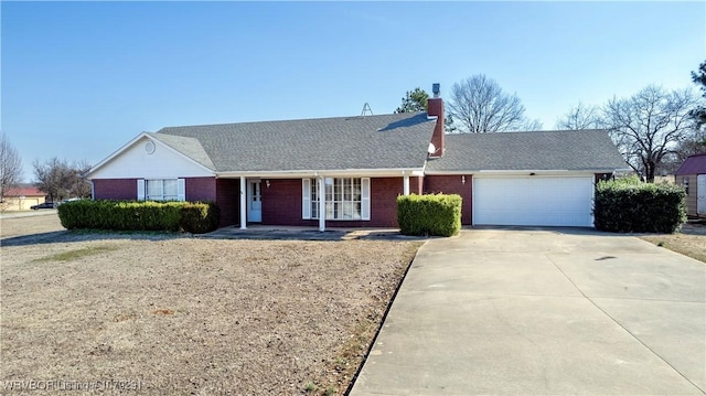 single story home with brick siding, roof with shingles, a chimney, an attached garage, and driveway