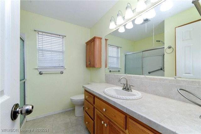 full bathroom featuring tile patterned flooring, toilet, a shower with shower door, vanity, and baseboards