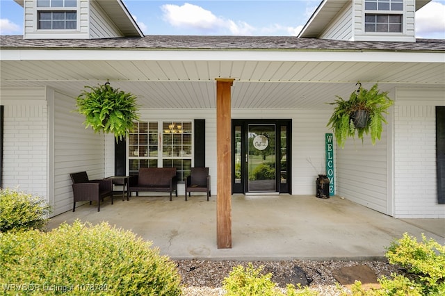 view of exterior entry with covered porch