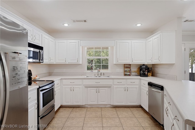 kitchen featuring sink, stainless steel appliances, and white cabinets