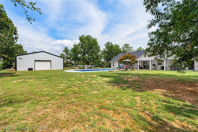 view of yard with a garage and an outdoor structure