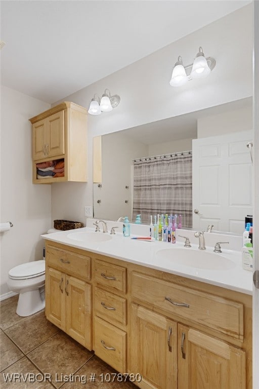 bathroom featuring walk in shower, vanity, toilet, and tile patterned flooring