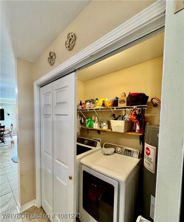 195 Polk 492, Cove, AR 71937 - washroom featuring water heater and light tile patterned flooring