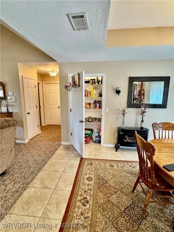 195 Polk 492, Cove, AR 71937 - dining room with light tile patterned floors, baseboards, and a textured ceiling